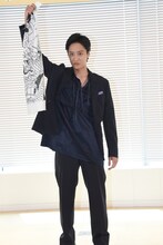 「すじぼり」の手ぬぐいを見せる藤原季節。