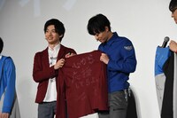 井上祐貴（右）にジャケットを贈る平田雄也（左）。