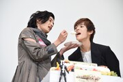 奥野壮（右）にケーキを食べさせる渡邊圭祐（左）。