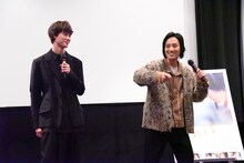 鍋をスタッフに振舞った様子を再現する藤原季節（右）。