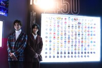 「THE HENSHIN COMPLETE SELECTION MODIFICATION EXHIBITION VOL.1」の会場を回る高橋文哉（左）と奥野壮（右）。