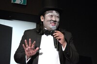 手のひらに描かれた肉球を見せるロバート秋山。