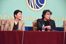 映画を作る際の目標を聞かれて照れるポン・ジュノ（右）と、彼の話に耳を傾けるソン・ガンホ（左）。