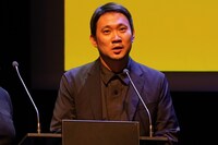 授賞式でスピーチする濱口竜介。