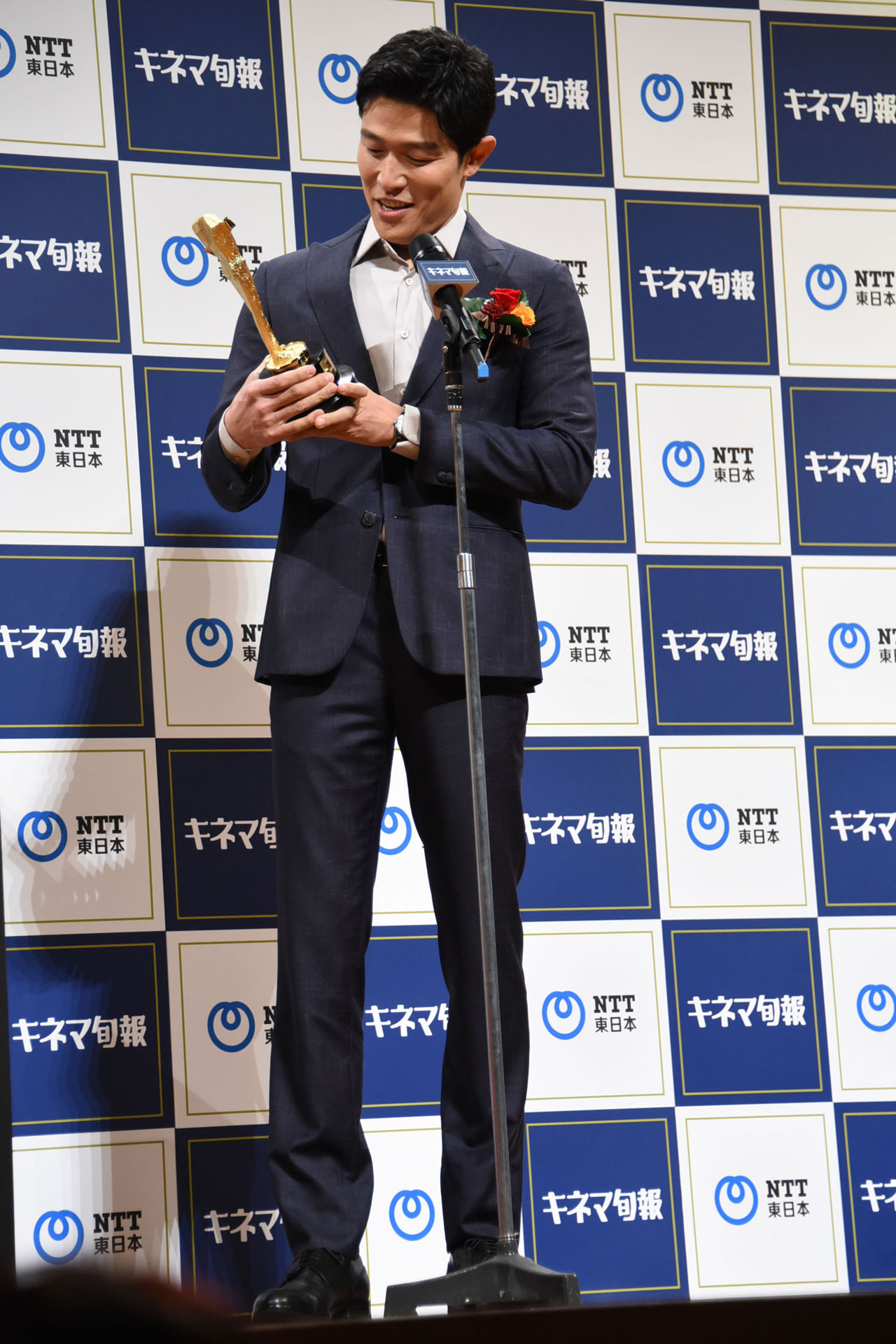 トロフィーの重みを感じる鈴木亮平。