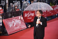 スマートフォンで撮影しながら歩く樋口真嗣。