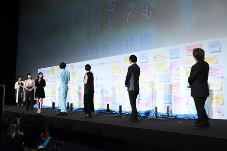 集まった感想コメントが記載されたボードを見つめる登壇者たち。