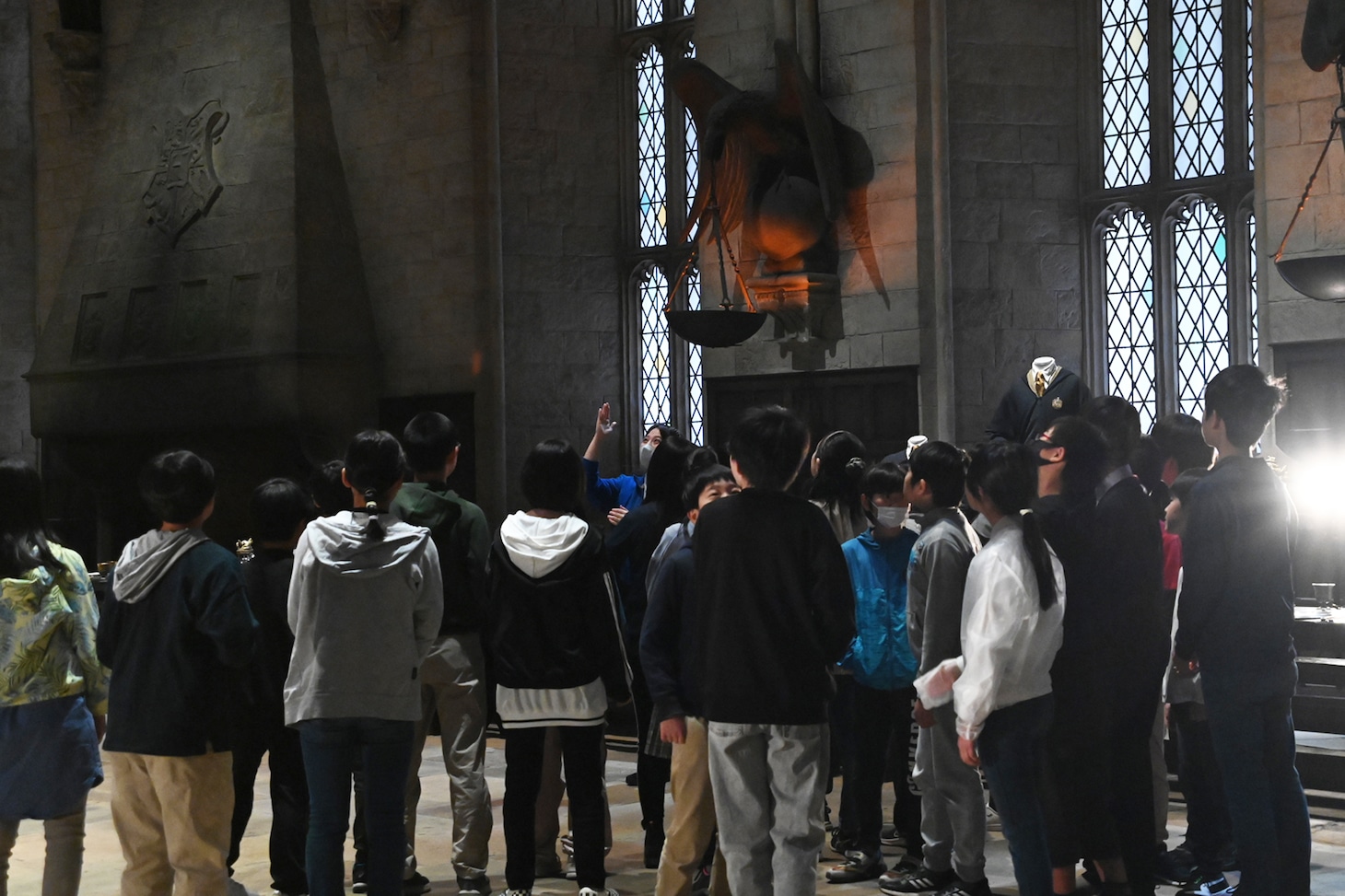 ホグワーツ魔法魔術学校の大広間を見学する小学生たち。