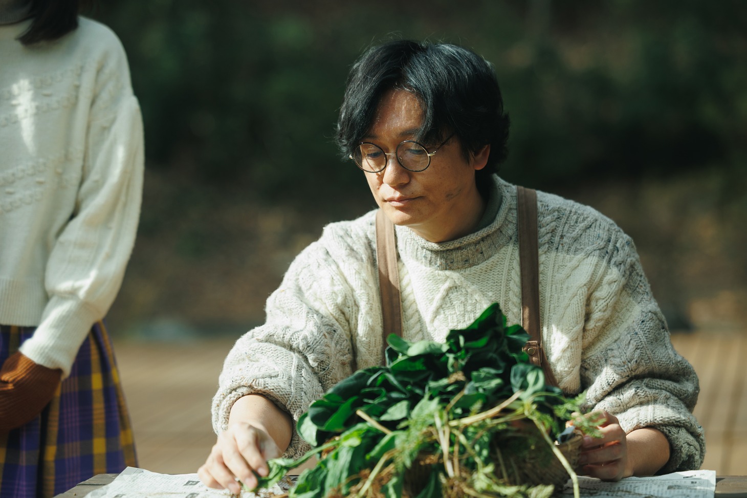 「人生に詰んだ元アイドルは、赤の他人のおっさんと住む選択をした」新場面写真より、野菜を収穫するササポン。