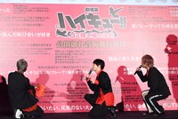 SNSの投稿文が印刷されたボードを見る登壇者たち。