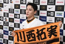 オリジナルタオルを手にする川西拓実。