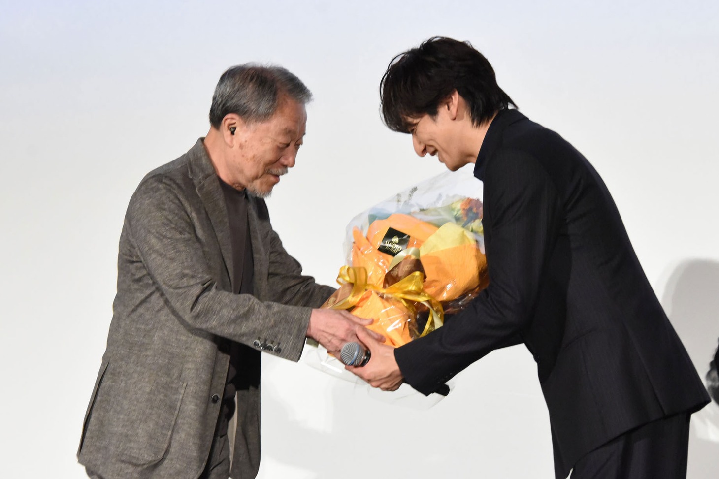 かわぐちかいじ（左）から花束を受け取る生田斗真（右）。