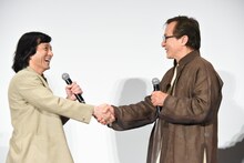 ジャッキーちゃん（左）と握手するジャッキー・チェン（右）。