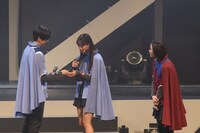 本島純政（左）からハンカチを受け取る松本麗世（中央）