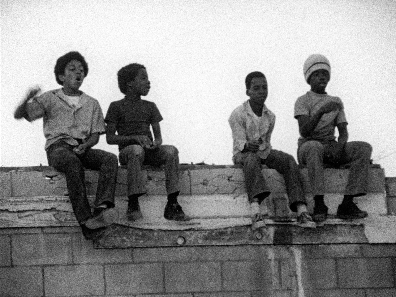 「キラー・オブ・シープ」場面写真。壁の上に座る少年たち ©1977 Charles Burnett ©2025 Milestone Film & Video for KILLER OF SHEEP