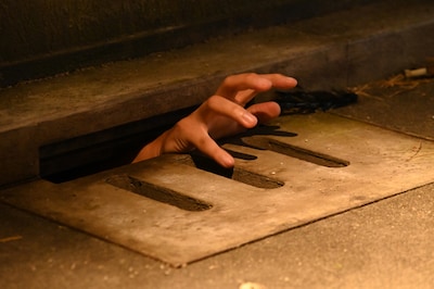 「ホラーにふれる展 －映画美術の世界－」に用意されたフォトスポット。排水溝から手を出すことができる