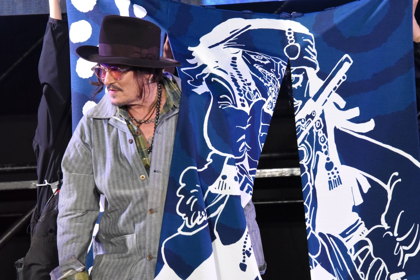 ジャック・スパロウが描かれた暖簾をくぐるジョニー・デップ