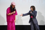 映画「炎上」初日舞台挨拶より、長久允（左）の“炎上カラー”のファッションを紹介する森七菜（右）