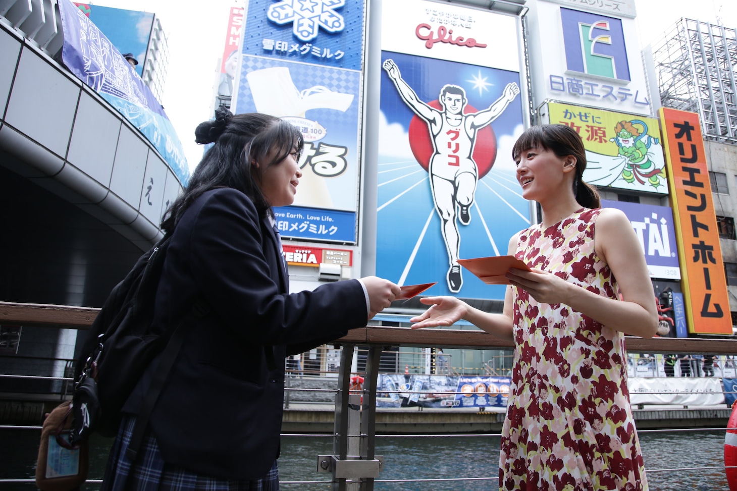 「人はなぜラブレターを書くのか」大阪・道頓堀のグリコサイン前でのプロモーションの様子。ラブレターを手渡しする綾瀬はるか（右）