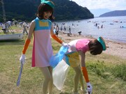 ゴミを拾うレナと、ゴミを見つけて満面の笑みを浮かべるリサ。