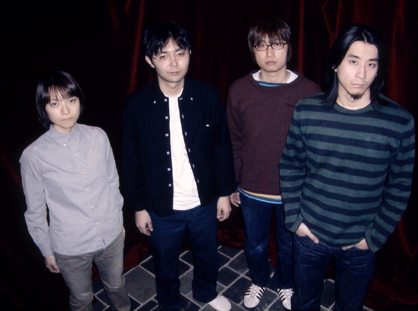 田渕ひさ子（G）、向井秀徳（Vo, G）、アヒト・イナザワ（Dr）、中尾憲太郎（B）の4人によるバンドNUMBER GIRL。2002年解散。