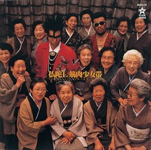 写真は1988年にリリースされたメジャー1stアルバム「仏陀L」ジャケット。大槻ケンヂと三柴江戸蔵（三柴理）の周りを囲む15人のお婆さんは、筋肉少女帯のメンバーではない。