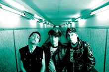 写真左からHIKAGE（THE STAR CLUB）、IWATA（The STRUMMERS）、OHNO（THE RYDERS）。80年代から日本のパンクシーンを牽引してきた3バンドが、新宿LOFTで「DOLL」への鎮魂歌（＝パンクロック）を爆音で鳴らす。