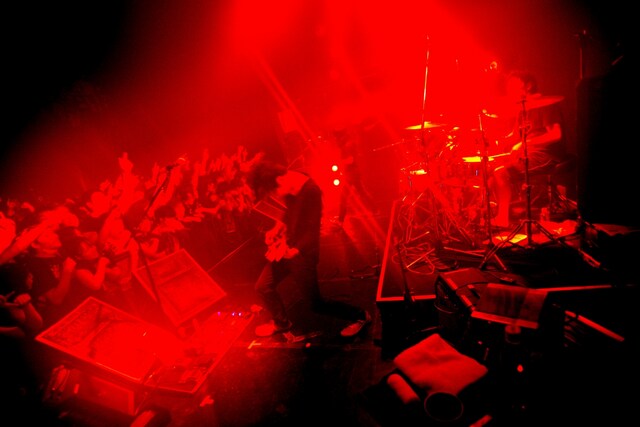 狭い会場のためフロア全体が常にモッシュピット状態に。3人はその熱気に油を注ぐ豪速球ナンバーをたたみ掛けるように投下し、密室を轟音で満たし続けた。