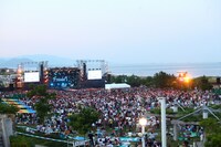 夜には、オーディエンスがライターや携帯電話を使って光の海を作り出す場面も。