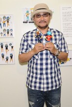 チャゲアースを両手に持ってはにかむChage。