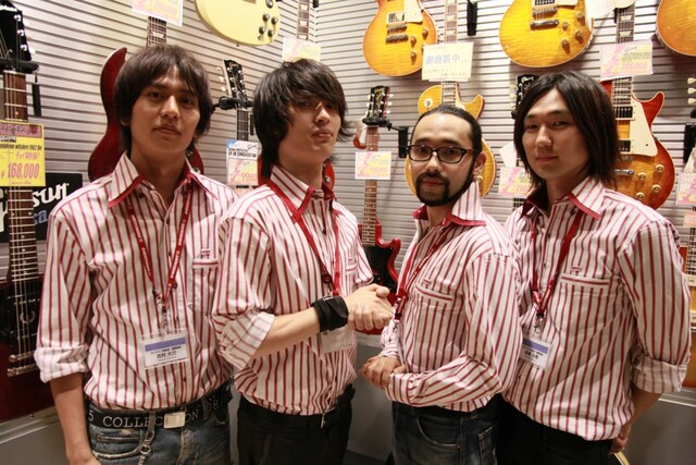 ギターコーナーの前に立つ4人。