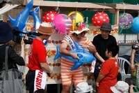 “2代目”がくじ引きで当てたイルカの浮き輪にサインを入れる港カヲル。