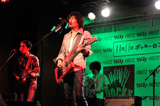 写真は11月7日の記者会見で披露されたライブ演奏の様子。ポッキーギターを爪弾きながら歌う斉藤和義（写真中央）。