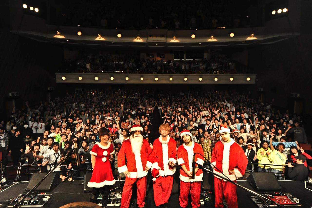サンタ服姿で満員のファンと記念撮影をするBIGMAMA。