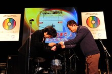 神聖かまってちゃんの代理で準大賞の盾を受け取る劔樹人マネージャー。