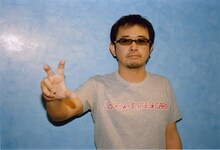 「LOVE & PEACE & CARP」Tシャツを身に着けた奥田民生。