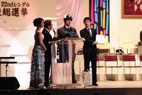 司会の2人に投票結果を渡す第三者機関のスタッフ。