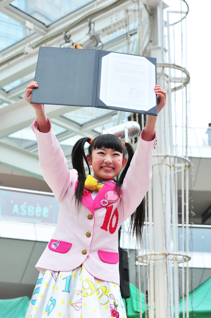 調印書を掲げる柏木ひなた。