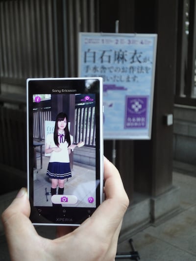 対応スマートフォンをポスターに向けるとメンバーの姿が現れる。