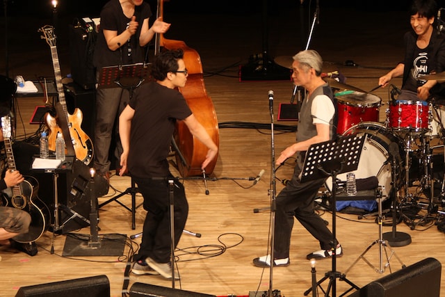 ダンスを披露する岸田繁（写真左）と細野晴臣（右）。