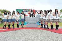 歌碑と記念撮影するSKE48。 (c)AKS