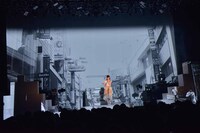 渋谷の街を映したムービーをバックに歌う武藤彩未。