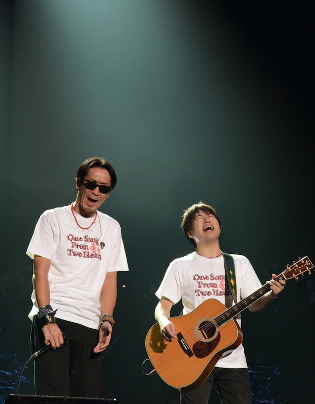 京セラドーム大阪のステージに立ち、マイクレスで熱唱するコブクロ。