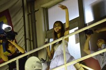 バルコニーから劇場外に集まったファンへあいさつする板野友美。 (c)AKS