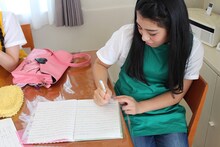 ノートに文字を書く坂本遥奈。