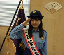 女性警察官の制服姿で敬礼する武田舞彩（GEM）。