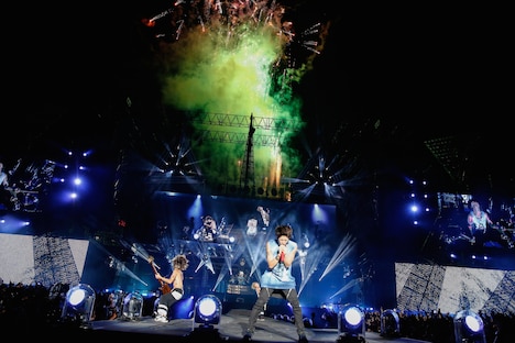 ライブの終盤で、花火をバックに熱演を繰り広げるONE OK ROCK。