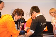 iPhone購入者にサインをする福士蒼汰、相沢梨紗、松岡修造。