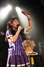 等身大パネルの代わりに置かれたさつまいもを手に不平を漏らす堀くるみ。