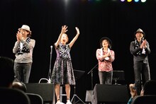 観客の声援に答える加藤いづみと演奏メンバー。